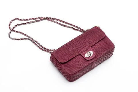 Luxury red snakeskin python leather handbag isolated on a white background. Photos