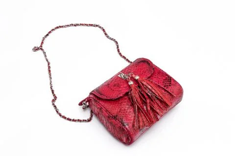 Luxury red snakeskin python leather handbag isolated on a white background. Stockfoto's