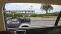 Luxury resort city, view from car window on street with palms and expensive cars 4k or 4k+ Resolution