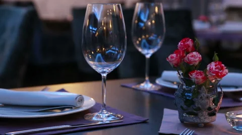 Luxury restaurant table layout with red roses for a romantic dinner Stock Footage 48618139