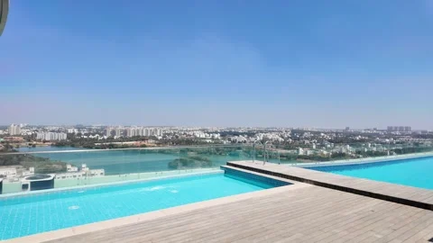 Luxury Rooftop Infinity Pool with City Skyline View. Bangalore Real estate Stock Footage 329504337
