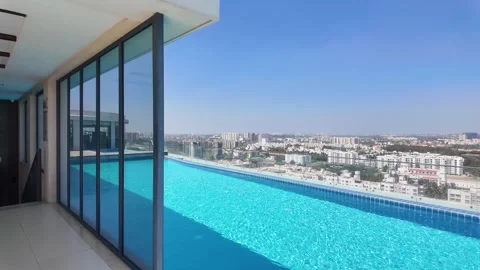 Luxury Rooftop Infinity Pool with City Skyline View. Bangalore Real estate Stock Footage 329504371