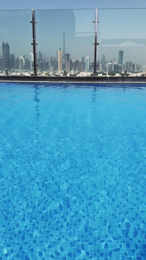 Luxury rooftop swimming pool view with Dubai downtown skyline in background,  Vídeos de archivo 336081090
