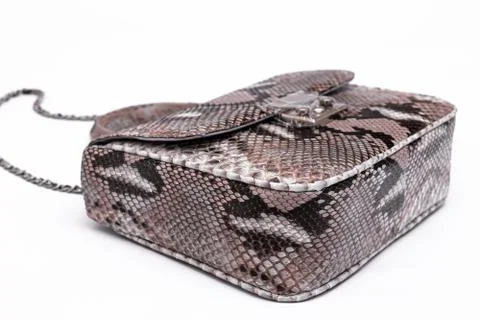 Luxury snakeskin python leather handbag isolated on a white background. Photos