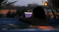 luxury spa - woman looking photo on tablet in jacuzzi at night HD Footage