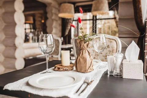 Luxury table setting for couples dining in a restaurant in pastel colors clos Stock Photos