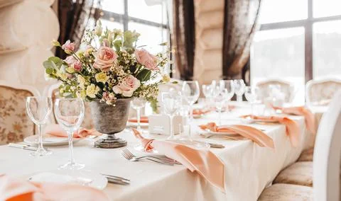 Luxury table setting for dining in a restaurant in pastel colors close up. We Stock Photos