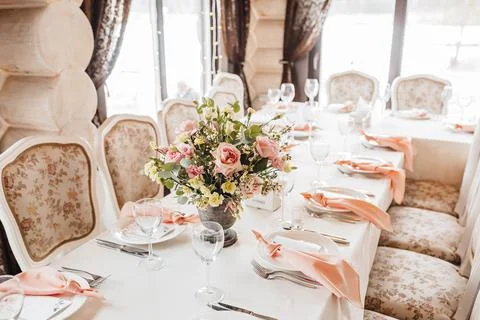 Luxury table setting for dining in a restaurant in pastel colors close up. We Stock Photos