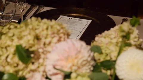 Luxury table setting with menu and flowers, rack focus, closeup 動画素材 104820111