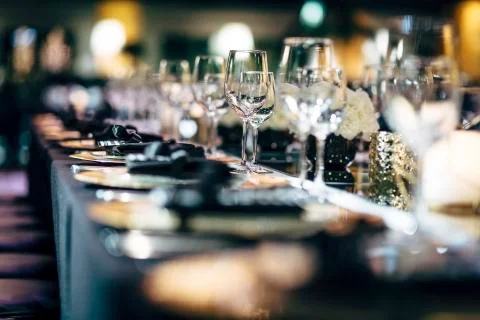 Luxury table settings for fine dining with and glassware, beautiful blurred   Stockfoto's