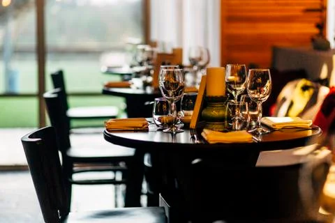 Luxury table settings for fine dining with and glassware, beautiful blurred   Stock Photos