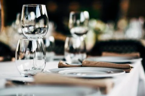 Luxury table settings for fine dining with and glassware, beautiful blurred   Stock Photos