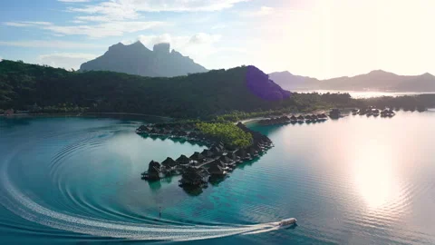 Luxury travel vacation aerial of overwater bungalows resort in coral reef lagoon Stock Footage