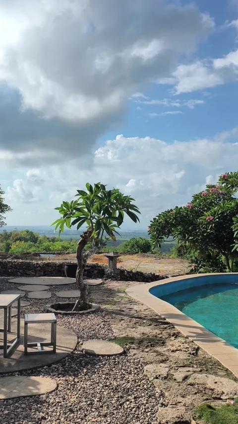 Luxury Tropical Villa Pool Overlooking Scenic Valley and Sky Stock Footage 340464660