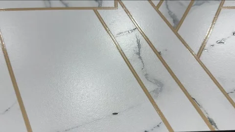 Luxury white marble tile with geometric golden carving lines and gray veins Stock Footage 331120149