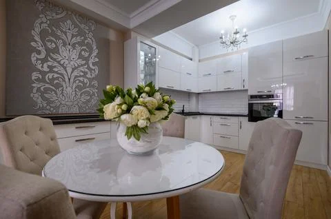 Luxury white modern kitchen with dining table Stock Photos