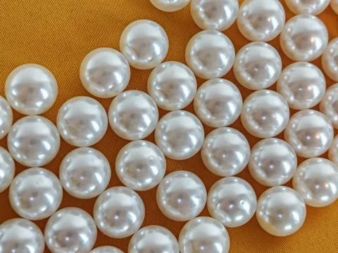 Luxury White Pearl Texture Pattern on Golden Fabric Background Stock Photos