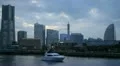Luxury Yacht Boat Passing Cruise Ship Minato Mirai 21 Yokohama Skyline Landmarks HD Footage