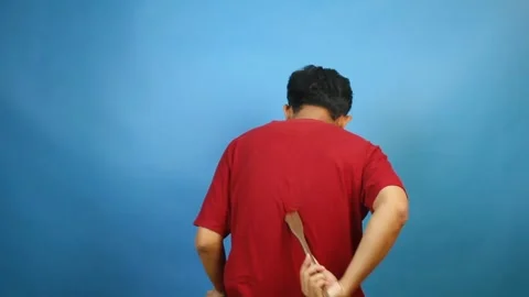 LvAsian man scratching itchy back with scratcher isolated on blue background Stock Footage 327096369