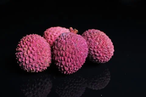 Lychee fruit on black mirror background. pink fruits as background Foto stock