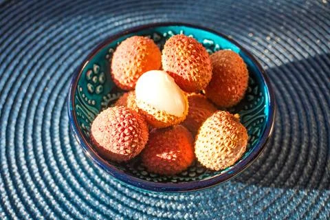 Lychee fruit on blue plate background, fresh ripe lychee peeled from lychee tree Stock Photos