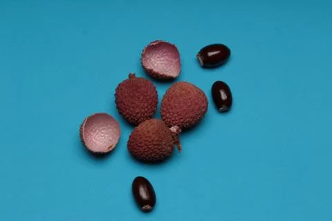 Lychee fruit scattered on a blue background Stock Photos