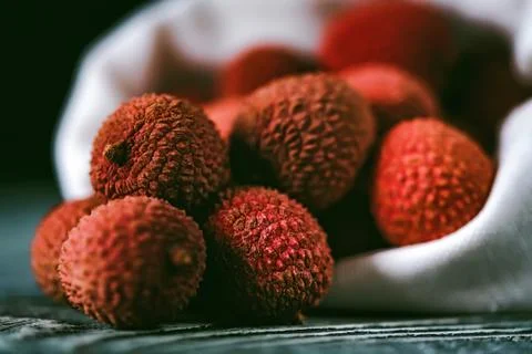 Lychee fruit in white sack close Stock Photos