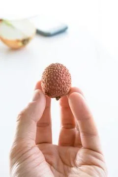 Lychee in the man's hand Stock Photos