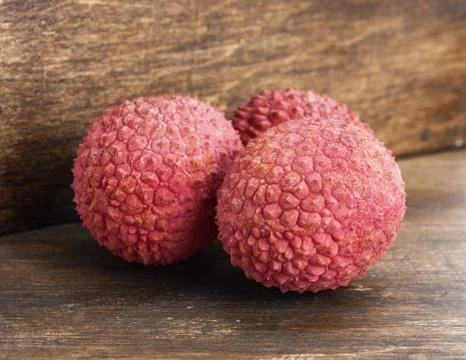 Lychee on wood background Stock Photos
