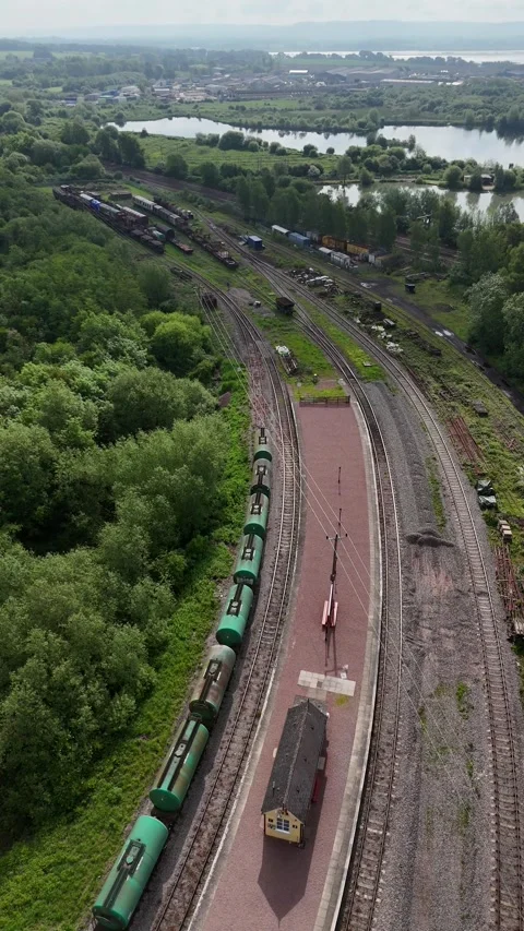 Lydney junction platform, railway siding portrait format aerial Stock Footage 294915280