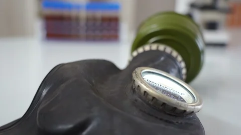 Lying black hazard mask with the coronavirus or Covid-19 on the eyeshield Stock Footage 129345706