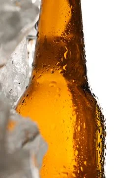 Lying bottle of malt on ice cubes. Close up. White background Stock Photos