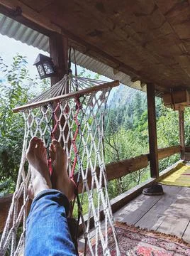 Lying down in hammock in a cottage Stock Photos