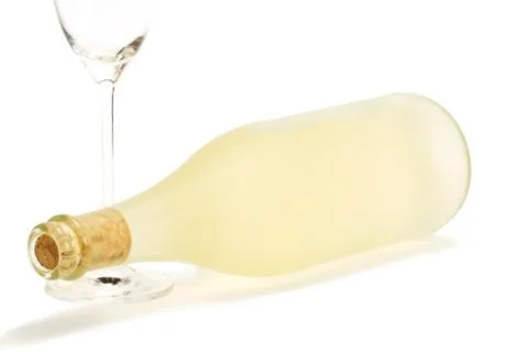 Lying dull prosecco bottle with a empty champagne glass Stock Photos