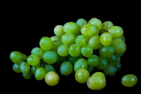 Lying grapes on black background Stock Photos