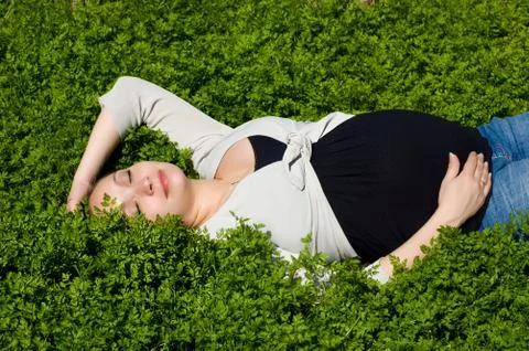 Lying in green grass Stock Photos