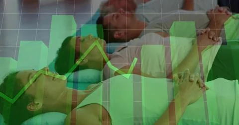 Lying six people practicing relaxation in studio on exercise mats, in activewear Stock Photos