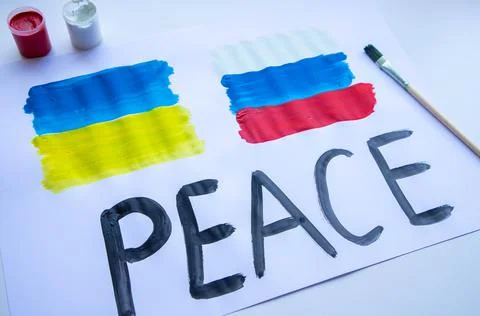Lying on the table a poster with the flag of Ukraine and Russia Stock Photos