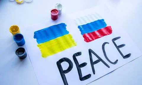 Lying on the table a poster with the flag of Ukraine and Russia Stock Photos