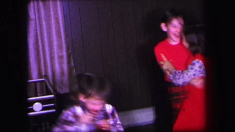 LYNBROOK NEW YORK-1971: Fast Motion Video Of Kids Playing Indoors With Two Girls Stock Footage 123545949