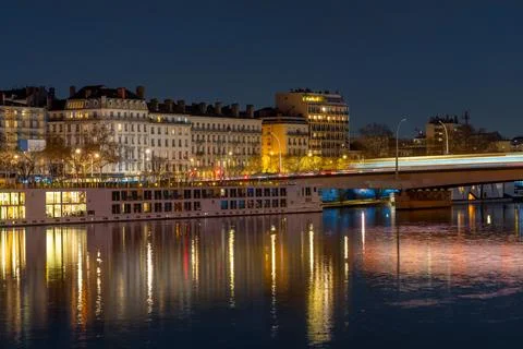 Lyon cityscape at dusk with river reflections and illuminated bridge Stock Photos