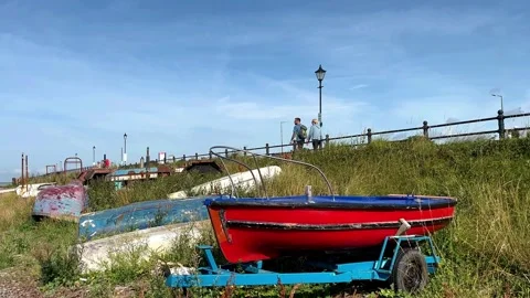 Lytham St Annes, UK 28 July, 2024; Old boats on pebble beach shoreline. 4K Video Stock Footage 280384543