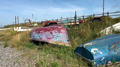Lytham St Annes, UK 28 July, 2024; Old boats, pebble beach shoreline. 4k Video Stock Footage 280384553