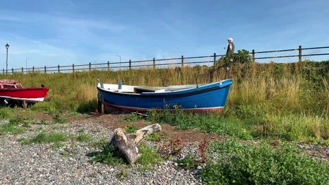 LYTHAM St Annes, UK 28 July, 2024; Old boats, pebble beach shoreline. 4k Video Stock Footage 280384554