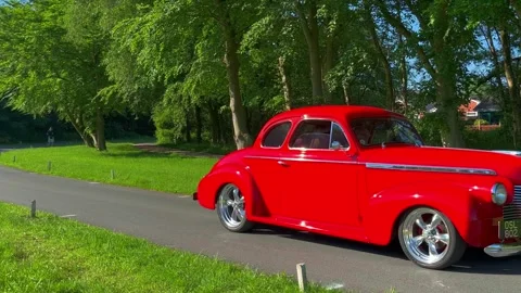 Lytham UK. 19 May 2024: 1940 red Chevrolet GMC and 1977 British Land Rover SUV Stock Footage 276158982