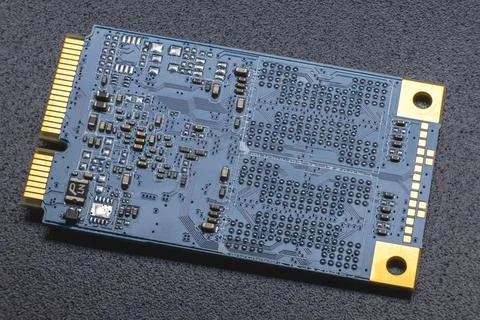 M.2 format SSD module. Close-up of an electronic board with gold-plated conta Stock Photos