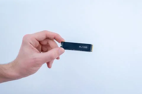 M2 ssd solid state drive held in hand isolated on white background, high sp.. Stock Photos