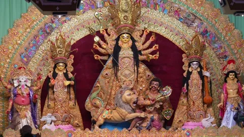 Maa Durga idol with attendant deities in a golden decorated pandal during D.. Stock Footage 346729864