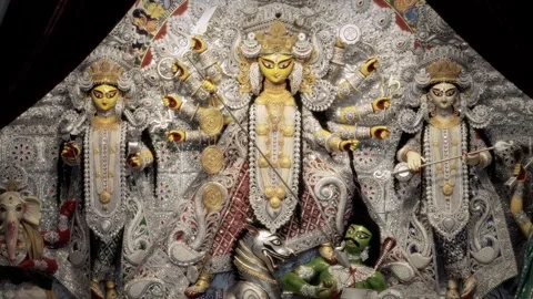Maa Durga idol with many arms, weapons and silver ornaments with lion at Du.. Stock Footage 346729868