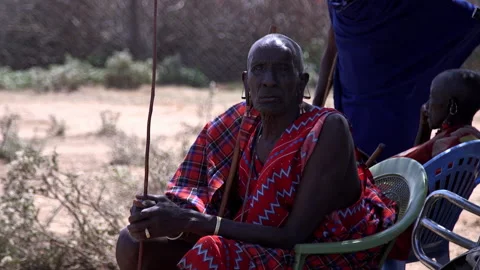 Maasai Elder Shades From The Midday Sun Stock Footage